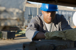 A picture of a handsome construction worker with a blue hard hat.