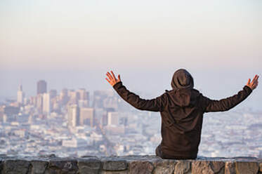 A male putting his hands up in front of view.