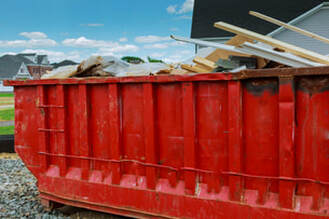 Red dumpster filled with debris