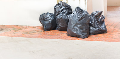 4 garbage bags on the floor